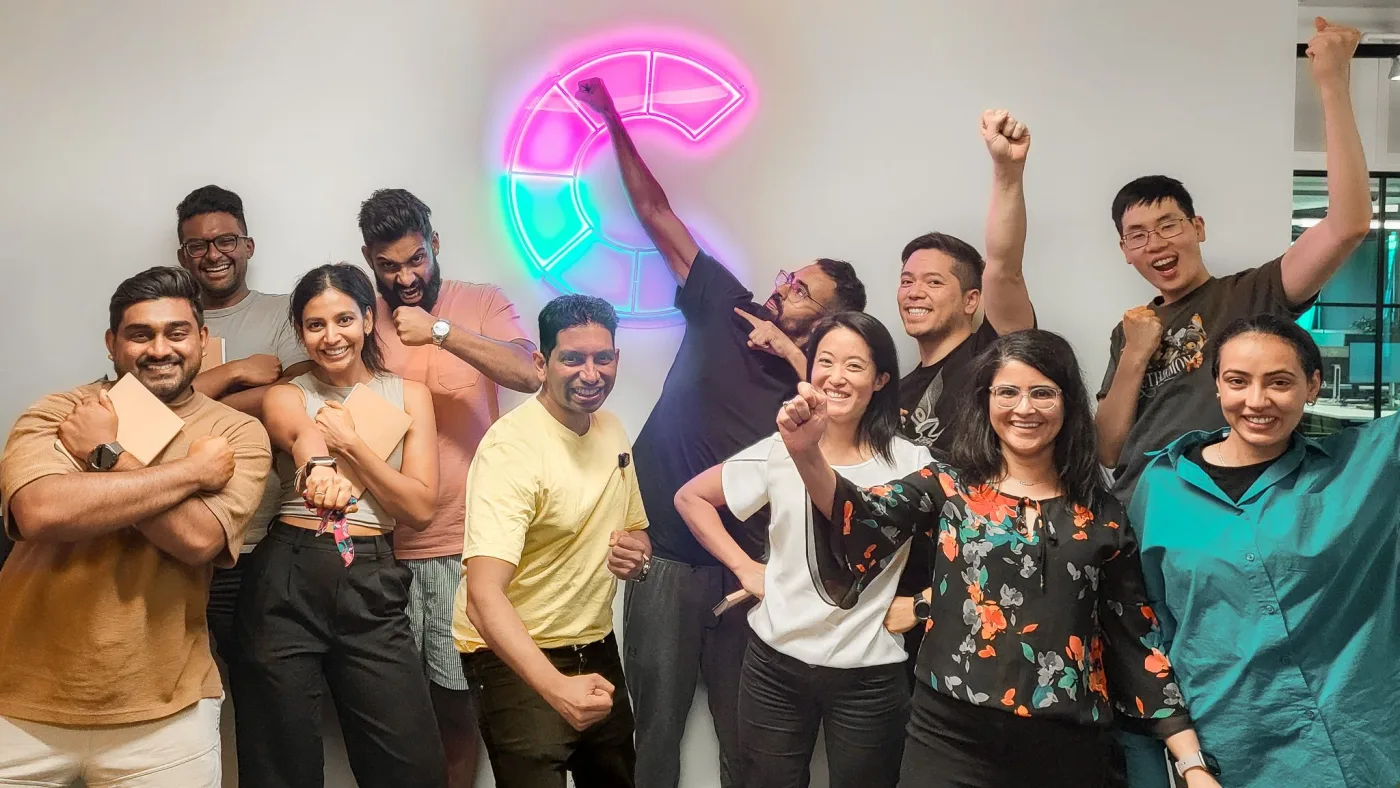 A PowerUp cohort celebrating together at the end of a session, arms raised